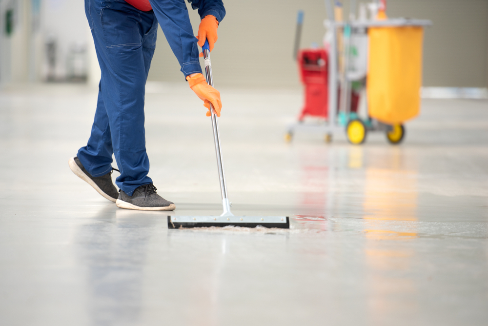 Professional floor cleaner conducting floor care.