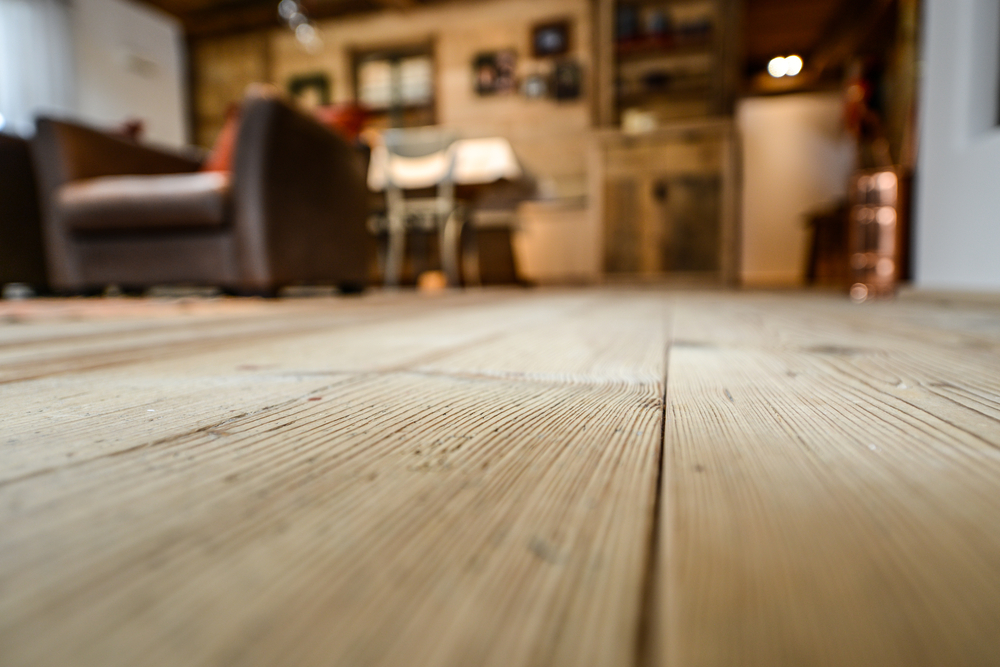 Closeup of floors in a home which are in need of wood floor care.